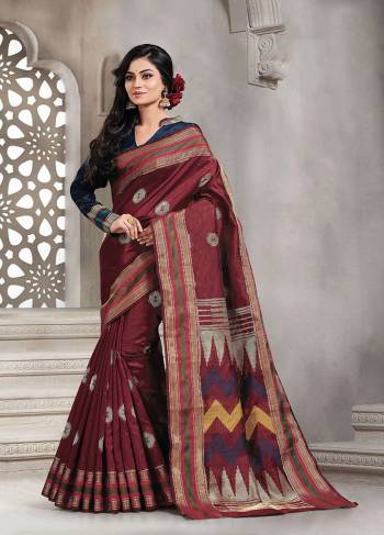 Add This Pretty Rich And Elegant Looking Saree In Maroon Color Paired With Contrasting Navy Blue Colored Blouse. This Saree And Blouse are Handloom Silk Based Beautified With Weave. Buy This Saree Now.