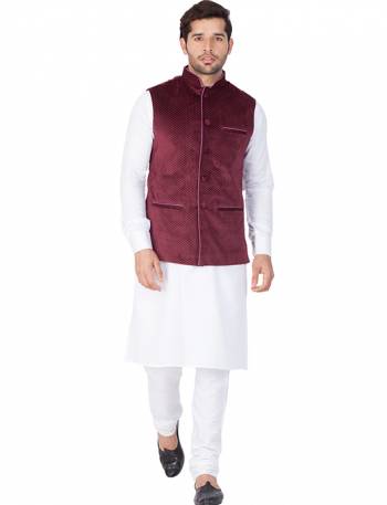 Here Is A Rich And Decent Looking Readymade Pair Of Men's Kurta Pyjama In White Color Paired With Wine Colored Jacket. This Kurta And Pyjama Are Fabricated On Cotton Paired With Velvet Fabricated Jacket. Buy This Pair For The Upcoming Wedding And Festive Season. 