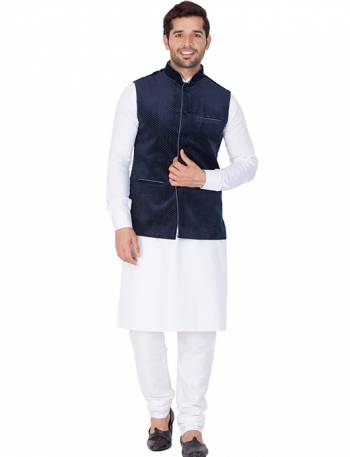 Here Is A Rich And Decent Looking Readymade Pair Of Men's Kurta Pyjama In White Color Paired With Navy Blue Colored Jacket. This Kurta And Pyjama Are Fabricated On Cotton Paired With Velvet Fabricated Jacket. Buy This Pair For The Upcoming Wedding And Festive Season. 