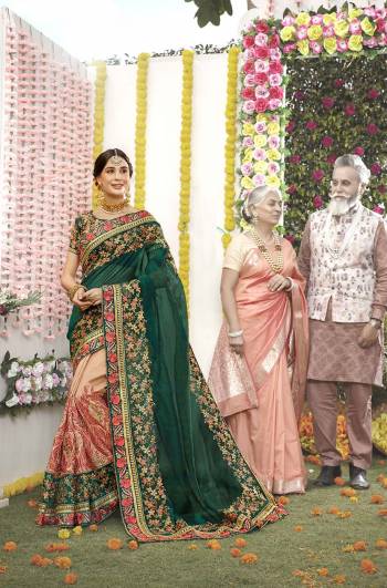 Here Is Heavy Deesigner Saree to Add Into Your Wardrobe For The Upcoming Festive And Wedding Season In Pine Green And Peach Color Paired With Pine Green Colored Blouse. Its Rich Fabric And Heavy Embroidery Will Earn You Lots Of Compliments From Onlookers.