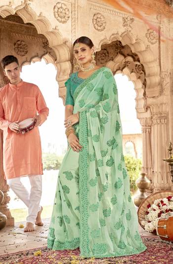 Here Is A Very Pretty Designer Saree to Add Into Your Wardrobe In Lovely Sea Green Color. This Heavy Embroidered Saree Is Fabricated On Chiffon Paired With Art Silk Fabricated Blouse. Buy Now.