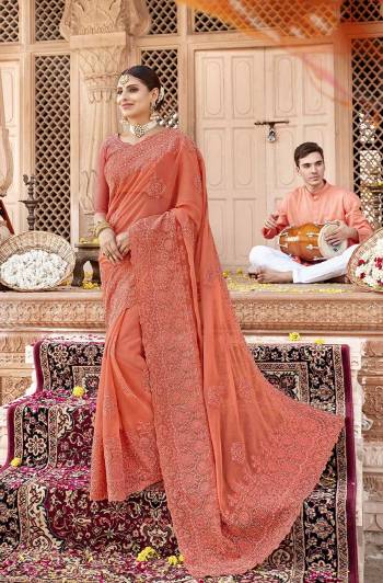 Here Is A Very Pretty Designer Saree to Add Into Your Wardrobe In Lovely Orange Color. This Heavy Embroidered Saree Is Fabricated On Chiffon Paired With Art Silk Fabricated Blouse. Buy Now.