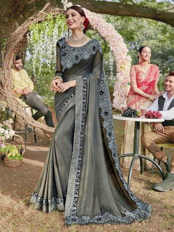 Celebrate This Festive Season In A Traditional Look Wearing This Heavy Designer Saree In Grey Color Paired With Black Colored Blouse. This Saree Is Fabricated On Shimmer Georgette Paired With Art Silk And Net Fabricated Blouse. Buy This Lovely Saree Now.