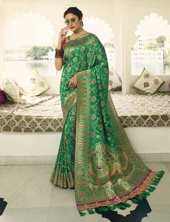 Celebrate This Festive Season In A Lovely Traditional Look With This Heavy Designer Saree In Green Color Paired With Rani Pink Colored Blouse. This Saree Is Fabricated on Banarasi Art Silk Beautified With Heavy Weave Paired with Art Silk Fabricated Blouse Beautified With heavy Embroidery.