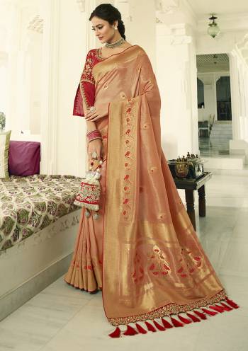 For A Proper Traditional Look, Grab This Designer Saree In Peach Color Paired With Contrasting Red colored Blouse. This Heavy Weaved Saree Is Banarasi Art Silk Based Paired With Art Silk Fabricated Heavy Embroidered Blouse. Buy This Saree Now.