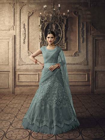 Here Is A Very Beautiful Heavy Designer Lehenga Choli For The Upcoming Wedding Season In All Over Aqua Blue Color. This Heavy Embroidered Lehenga Choli Is Net Based Beautified With Detailed Tone To Tone Embroidery. Buy This Rich And Elegant Looking Piece Now.