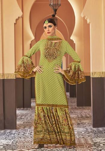 Adorn The Seasons Trend With This Trendy Designer Sharara Suit In Light Green Color. Its Top Is Fabricated On Georgette Paired With Crepe Satin Bottom And Chiffon Fabricated Dupatta. This Lovely Suit Is Beautified With Detailed Attractive Prints And Stone Work. Buy This Lovely Piece Now.