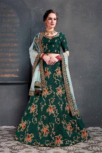 Grab This Heavy Designer Lehenga Choli For This Wedding Season In Pine Green Color Paired With Contrasting Sky Blue Colored Dupatta. This Pretty Lehenga Choli Is Satin Silk Based Paired With Net Fabricated Dupatta. Buy This Piece Now.