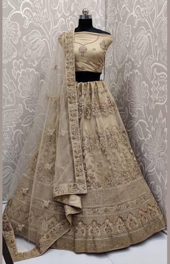 Look The Most Elegant Of All This Wedding Season Wearing This Heavy Designer Lehenga Choli In Beige Color. This Beautiful Heavy Tone To Tone Embroidered Lehenga Choli Is Fabricated On Net. Its Rich Color and Detailed Embroidery Will earn You Lots Of Compliments From Onlookers. 