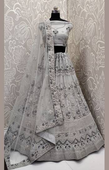 Look The Most Elegant Of All This Wedding Season Wearing This Heavy Designer Lehenga Choli In Grey Color. This Beautiful Heavy Tone To Tone Embroidered Lehenga Choli Is Fabricated On Net. Its Rich Color and Detailed Embroidery Will earn You Lots Of Compliments From Onlookers. 