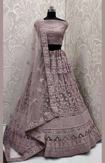 Look The Most Elegant Of All This Wedding Season Wearing This Heavy Designer Lehenga Choli In Mauve Color. This Beautiful Heavy Tone To Tone Embroidered Lehenga Choli Is Fabricated On Net. Its Rich Color and Detailed Embroidery Will earn You Lots Of Compliments From Onlookers. 