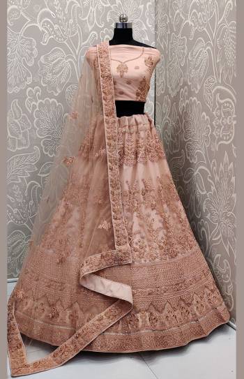 Look The Most Elegant Of All This Wedding Season Wearing This Heavy Designer Lehenga Choli In Peach Color. This Beautiful Heavy Tone To Tone Embroidered Lehenga Choli Is Fabricated On Net. Its Rich Color and Detailed Embroidery Will earn You Lots Of Compliments From Onlookers. 