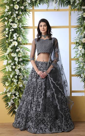 Flaunt Your Rich and Elegant Taste Wearing This Heavy Designer Lehenga Choli In Grey Color. This Pretty Tone To Tone Embroidered Lehenga Choli Is Fabricated On Net. Also It Is Light Weight And Easy To Carry Throughout The Gala.