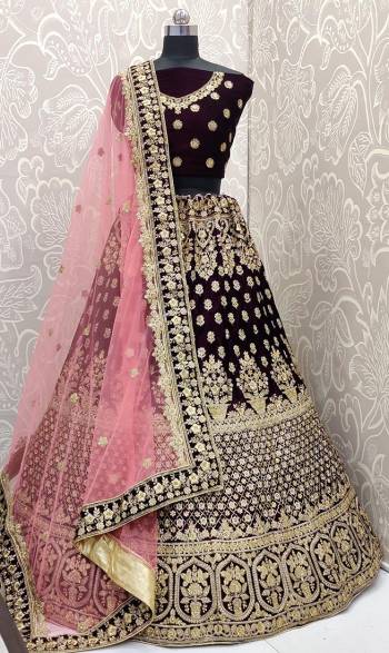 Here Is A Beautiful Designer Bridal Lehenga Choli In Wine Color Paired With  Pink Colored Dupatta. This Beautiful Heavy Lehenga Choli Is Fabricated On Velvet Paired With Net Fabricated Dupatta. It Is Beautified With Heavy Detailed Embroidery. Get Ready For Your D-Day With This Designer Piece And Look The Most Graceful Of All.