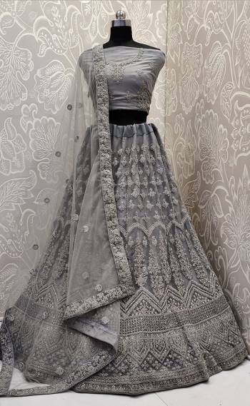 Look The Most Elegant Of All This Wedding Season Wearing This Heavy Designer Lehenga Choli In Grey Color. This Beautiful Heavy Tone To Tone Embroidered Lehenga Choli Is Fabricated On Net. Its Rich Color and Detailed Embroidery Will earn You Lots Of Compliments From Onlookers