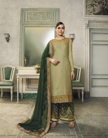 Here Is A Very Beautiful Designer Suit In Light Green Colored Top Paired With Dark Green Colored Bottom And Dupatta. This Semi-Stitched Suit Can Be Made As Lehenga Suit Or Plazzo Suit, Either Way You Like. Its Top Is Fabricated On Satin Silk Beautified With Detailed Embroidery Paired With Jacquard Silk Fabricated Bottom And Georgette Fabricated Stone Work Dupatta. 