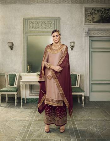 Get Ready For This Wedding And Festive Season With This Beautiful Designer Lehenga Or Plazzo Suit, You Can Get This Stitched In Either Of The Ways. This Pretty Suit Is In Pastel Peach Colored Top Paired With Contrasting Maroon Colored Bottom And Dupatta. Its Top Is Fabricated On Satin Silk Paired With Jacquard Silk Bottom And Georgette Fabricated Stone Work Dupatta. Buy This Lovely Piece Now.