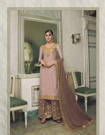 Get Ready For This Wedding And Festive Season With This Beautiful Designer Lehenga Or Plazzo Suit, You Can Get This Stitched In Either Of The Ways. This Pretty Suit Is In Light Lilac Colored Top Paired With Contrasting Mauve Colored Bottom And Dupatta. Its Top Is Fabricated On Satin Silk Paired With Jacquard Silk Bottom And Georgette Fabricated Stone Work Dupatta. Buy This Lovely Piece Now.