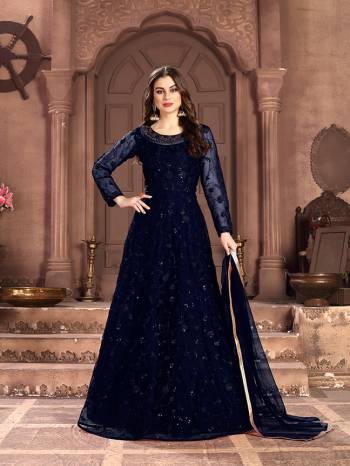 Adorn The Pretty Angelic Look Wearing This Designer Floor Length Suit In All Over Navy Blue Color. Its Pretty Top Is Fabricated on Net Beautified With Pretty Tone To Tone Embroidery Giving A Heavy Yet Subtle Look Paired With Santoon Bottom And Net Fabricated Dupatta. Buy Now.