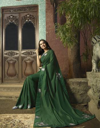 You Will Definitely Earn Lots Of Compliments Wearing This lovely Designer Saree In Dark Green Color Paired With Dark Grey Colored Blouse. This Saree And Blouse Are Silk Based With Pretty Elegant Embroidery. Buy Now.