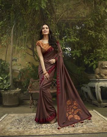 Shine Bright Wearing This Attractive Designer Saree In Brown Color Paired With Orange Colored Blouse. This Saree And Blouse Are Silk Based With Deatiled Patch Work. 