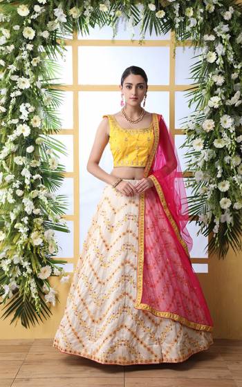 Look Pretty In This Lovely Designer Lehenga Choli In Yellow Colored Blouse Paired With Cream Colored Lehenga And Rani Pink Colored Dupatta. This Lehenga Choli Is Art Silk Based Paired With Net Fabricated Dupatta. Buy Now.