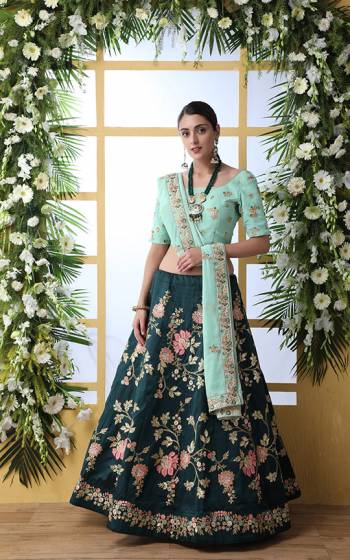 Catch All The Limelight At The Next Wedding You Attend Wearing This Heavy Designer Lehenga Choli In Aqua Blue Colored Blouse Paired With Teal Blue Colored Lehenga And Aqua Blue Colored Dupatta. Its Pretty Embroidered Blouse And Dupatta Are Fabricated on Georgette Paired With Detailed Embroidered Art Silk Fabricated Lehenga. 