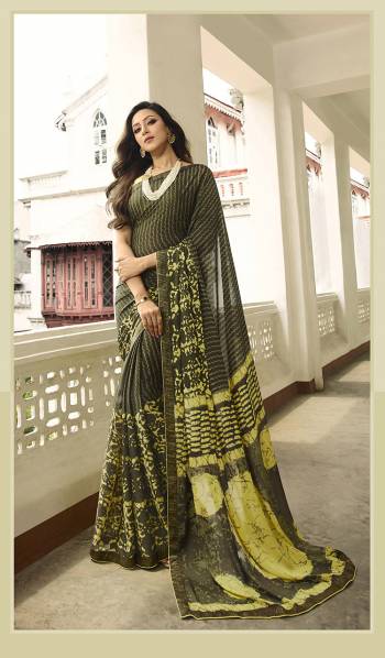 Here Is A Pretty Printed Saree For Your Semi-Casuals In Dark Olive Green Color. This Saree Is Fabricated On Georgette Paired With Art Silk Fabricated Blouse. It Is light In Weight And Easy To Drape. Buy This pretty Saree Now.