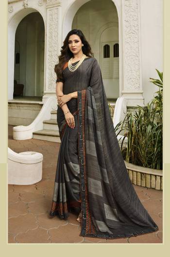 For Your Semi-Casual Wear, Grab This Pretty Saree In Dark Grey Color. This Printed Saree Is Fabricated On Georgette Paired With Art Silk Fabricated Blouse. Its Fabric Is Durable And Easy To Care For. 