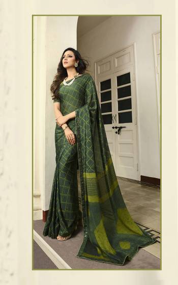 Here Is A Pretty Printed Saree For Your Semi-Casuals In Pine Green Color. This Saree Is Fabricated On Georgette Paired With Art Silk Fabricated Blouse. It Is light In Weight And Easy To Drape. Buy This pretty Saree Now.