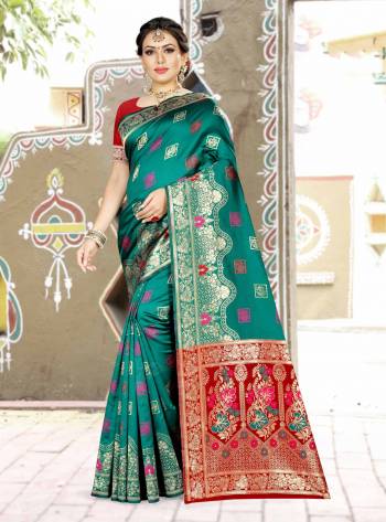 Grab This Designer Silk Based Saree In Sea Blue Color Paired With Contrasting Red Green Colored Blouse. This Saree And Blouse Are Fabricated On Banarasi Art Silk Beautified With Weave All Over. Buy Now.
