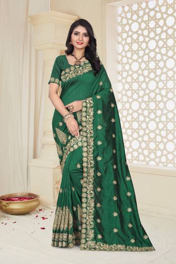 Grab This Designer Saree For The Upcoming Festive And Wedding Season In Dark Green Color. This Saree And Blouse Are Fabricated on Art Silk Beautified With Jari Embroidery. 