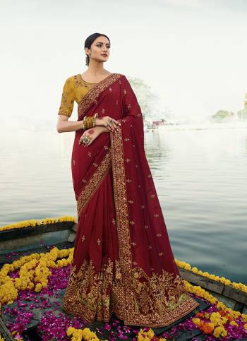 Get Ready For The Upcoming Wedding And Festive Season With This Heavy Designer Saree In Maroon Color Paired With Contrasting Musturd Yellow Colored Blouse. This Saree Is Fabricated On Soft Silk Paired With Art Silk Fabricated Blouse. Its Rich Color  Pallete Will Earn You Lots Of Compliments From Onlookers. 