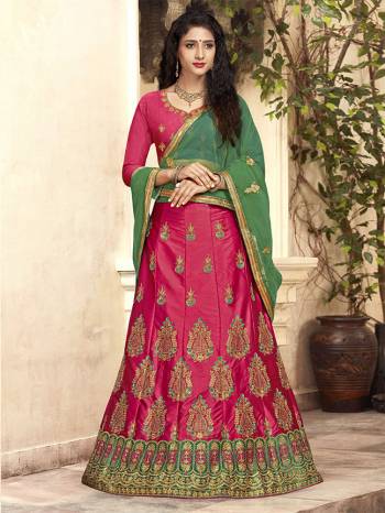 For A Proper Traditional Look, Grab This Heavy Designer Lehenga Choli In Rani Pink Color Paired With Contrasting Green Colored Blouse. Its Blouse Is Fabricated On Art Silk Paired With Satin Silk Lehenga And Net Fabricated Dupatta. It Is Beautified With Attractive Embroidery. Buy This Pretty Piece Now.