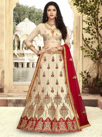 For A Proper Traditional Look, Grab This Heavy Designer Lehenga Choli In Beige Color Paired With Contrasting Red Colored Blouse. Its Blouse Is Fabricated On Art Silk Paired With Satin Silk Lehenga And Net Fabricated Dupatta. It Is Beautified With Attractive Embroidery. Buy This Pretty Piece Now.