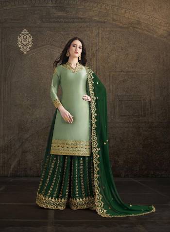 Get Ready For This Wedding And Festive Season With This Heavy Designer Suit In Light Green Colored Top Paired With Green Colored Bottom And Dupatta. Its Top And Bottom Are Fabricated On Satin Paired With georgette Fabricated Dupatta. Its Pretty Top, Bottom And Dupatta Are Beautified With Detailed Heavy Embroidery. 