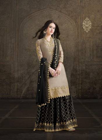 Flaunt Your Rich and Elegant Taste Wearing This Heavy Designer Suit In Sand Grey Color Paired With Black Colored Bottom And Dupatta. This Beautiful Heavy Embroidered Suit Is Fabricated on Satin Paired With Georgette Fabricated Dupatta. 