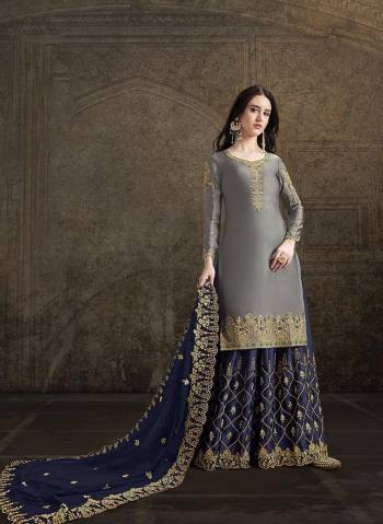 Look Pretty In This Heavy Embroidered Designer Suit In Grey Color Paired With Contrasting Navy Blue Colored Bottom And Dupatta, Its Top And Bottom Are Satin Based Paired With Georgette Fabricated Dupatta. Buy This Lovely Suit Now. 