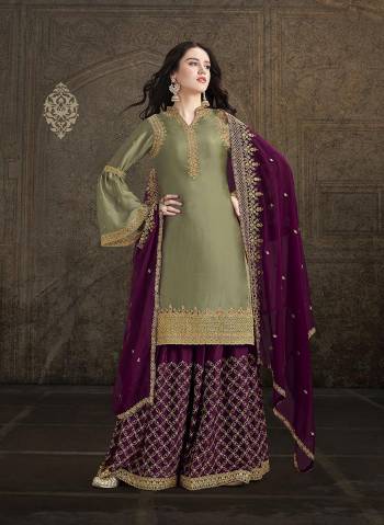 Flaunt Your Rich and Elegant Taste Wearing This Heavy Designer Suit In Olive Green Color Paired With Wine Colored Bottom And Dupatta. This Beautiful Heavy Embroidered Suit Is Fabricated on Satin Paired With Georgette Fabricated Dupatta. 