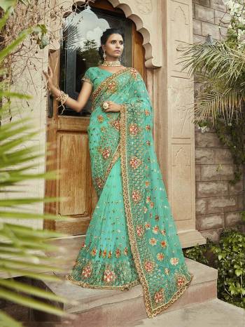 Add This Beautiful Designer Saree To Your Wardrobe For the Upcoming Wedding Season In Sea Green Color. This Saree Is Fabricated On Net Paired With Georgette Fabricated Blouse. It Is Beautified With Heavy Detailed Embroidery Giving You An Attractive Look. 