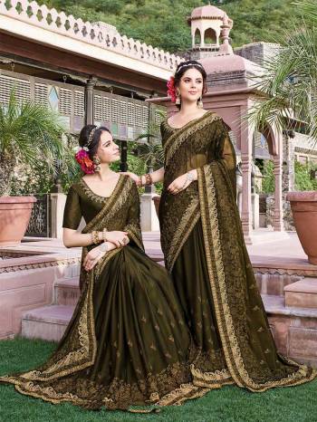 Grab This Heavy Designer Saree In Dark Olive Green Color Paired With Dark Olive Green Colored Blouse. This Heavy Embroidered Saree Is Fabricated On Georgette Paired With Art Silk Fabricated Blouse. It Is Easy To Drape And Carry All Day Long. 