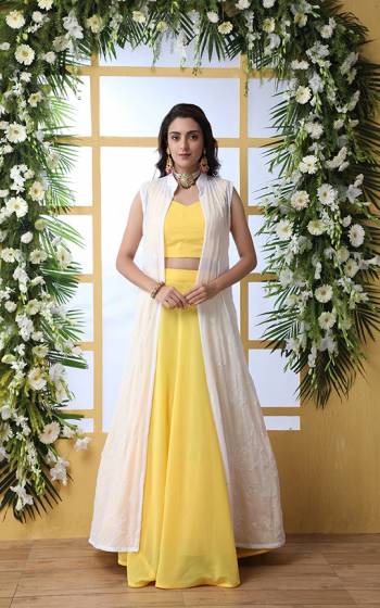 Grab This Designer Indo-Western Lehenga Choli With This Pretty Yellow Colored Blouse And Lehenga Paired With A White Colored Tone To Tone Embroidered Jacket. This Whole Dress Is Georgette Based Which IS Durable And Easy To Care For.