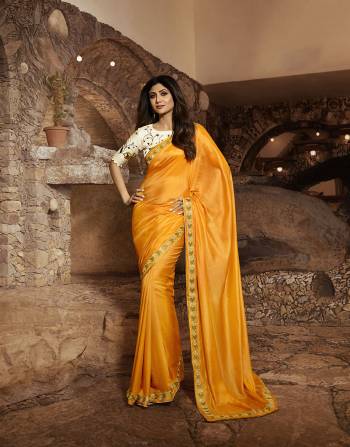 Celebrate This Festive Season With Beauty And Comfort Wearing This Designer Saree In Musturd Yellow Color Paired With Cream Colored Blouse. This Saree Is Fabricated On Satin Silk Paired With Art Silk Fabricated Blouse. It Is Beautified With Elegant Resham & Jari Embroidery. 