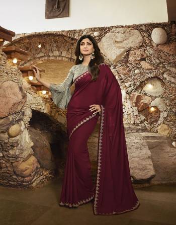 For A Royal Look, Grab This Rich And Elegant Looking Designer Saree In Maroon Color Paired With Contrasting Teal Grey Colored Blouse. This Saree Is Fabricated on Soft Silk Paired With Satin Silk Fabricated Blouse. 