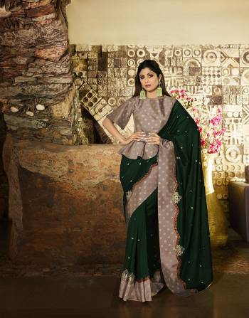 Here Is A Very Beautiful Designer Saree In Dark Green Color Paired With Contrasting Mauve Colored Blouse. This Saree Is Fabricated On Soft Silk Paired With Satin Silk Fabricated Blouse. Its Unique Color Pallete And Pattern Will Earn You Lots Of Compliments From Onlookers. 