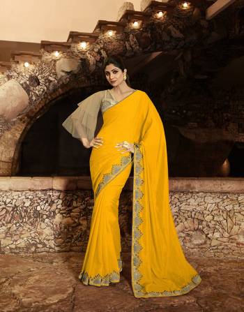 Add This Very Beautiful Designer Saree To Your Wardrobe In Yellow Color Paired With Beige Colored Blouse. This Saree Is Fabricated On Soft Silk Paired With Satin Silk And Net Fabricated Blouse. It Is Light Weight, Easy To Drape And Carry All Day Long. 