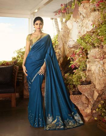 Enhance Your Personality Wearing This Designer Saree In Blue Color Paired With Elegant Golden Colored Blouse. This Saree Is Fabricated On Soft Silk Beautified With Minimal Embroidery Over The Border Paired With Satin Silk Fabricated Blouse. Buy This Saree Now. 