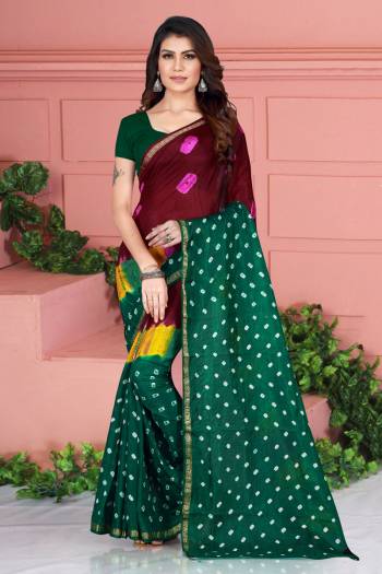 Grab This Pretty Designer Bandhani Saree In Maroon And Pine Green Color. This Saree And Blouse Are Fabricated On Tafeta Art Silk Beautified With Prints. It Is Light In Weight And Easy To Carry All Day Long. 