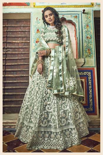 Here Is A Very Pretty Heavy Designer Lehenga Choli In Sea Green Color. This Lehenga Choli Is Fabricated On Net Paired With Net Fabricated Dupatta. It Is Beautified With Heavy Embroidery With Pretty Pearl Highlights. 