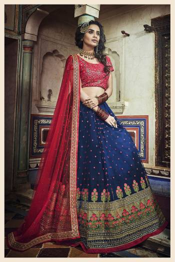 Bright And Visually Appealing Color Pallete Is Here With This Heavy Designer Lehenga Choli In Dark Pink Colored Blouse Paired with Contrasting Royal Blue Colored Lehenga And Dark Pink Dupatta. This Lehenga Choli Is Net Based Beautified With Heavy Embroidery. 